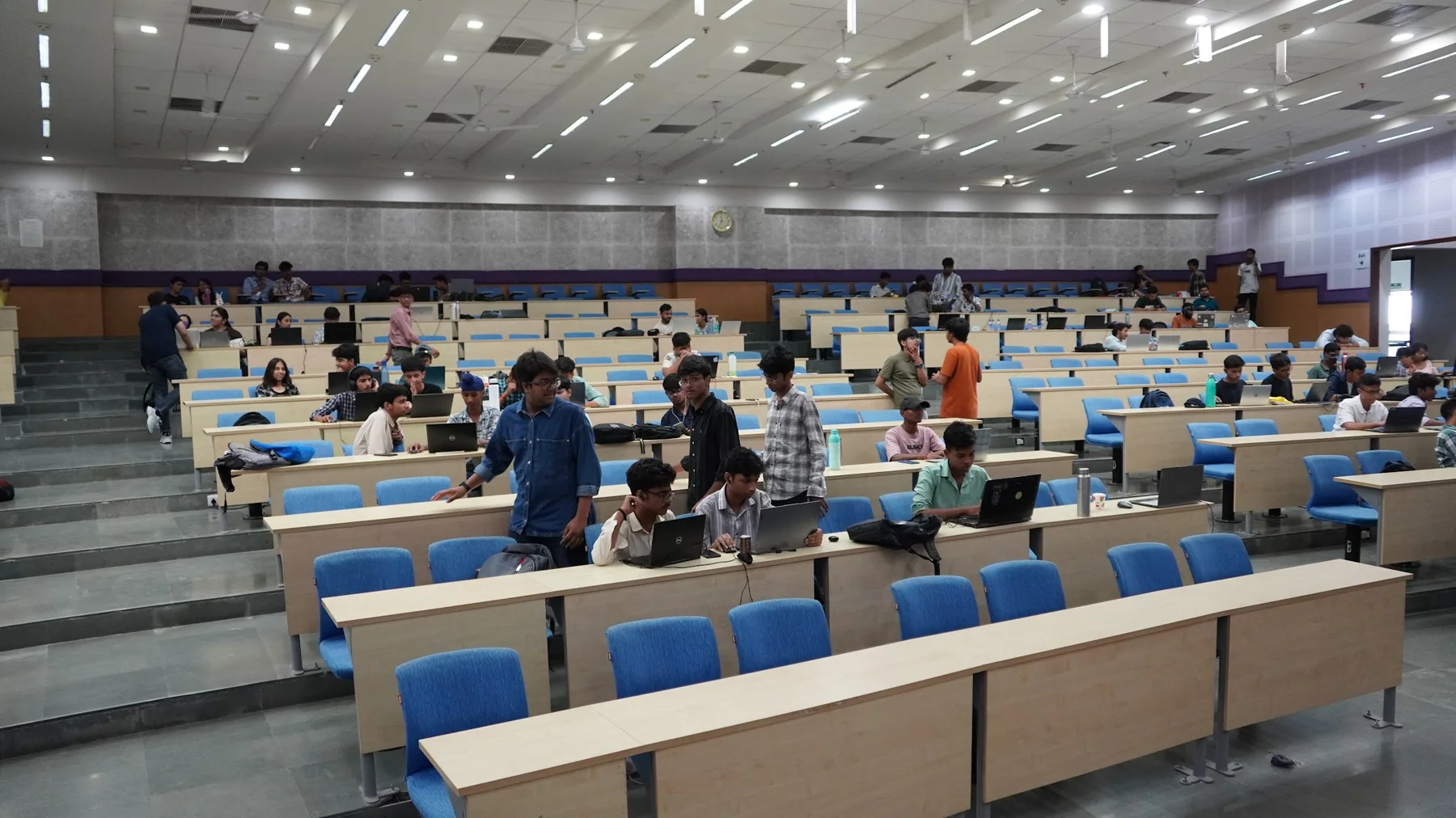 Students working in teams across the AAROH auditorium at IIIT Delhi