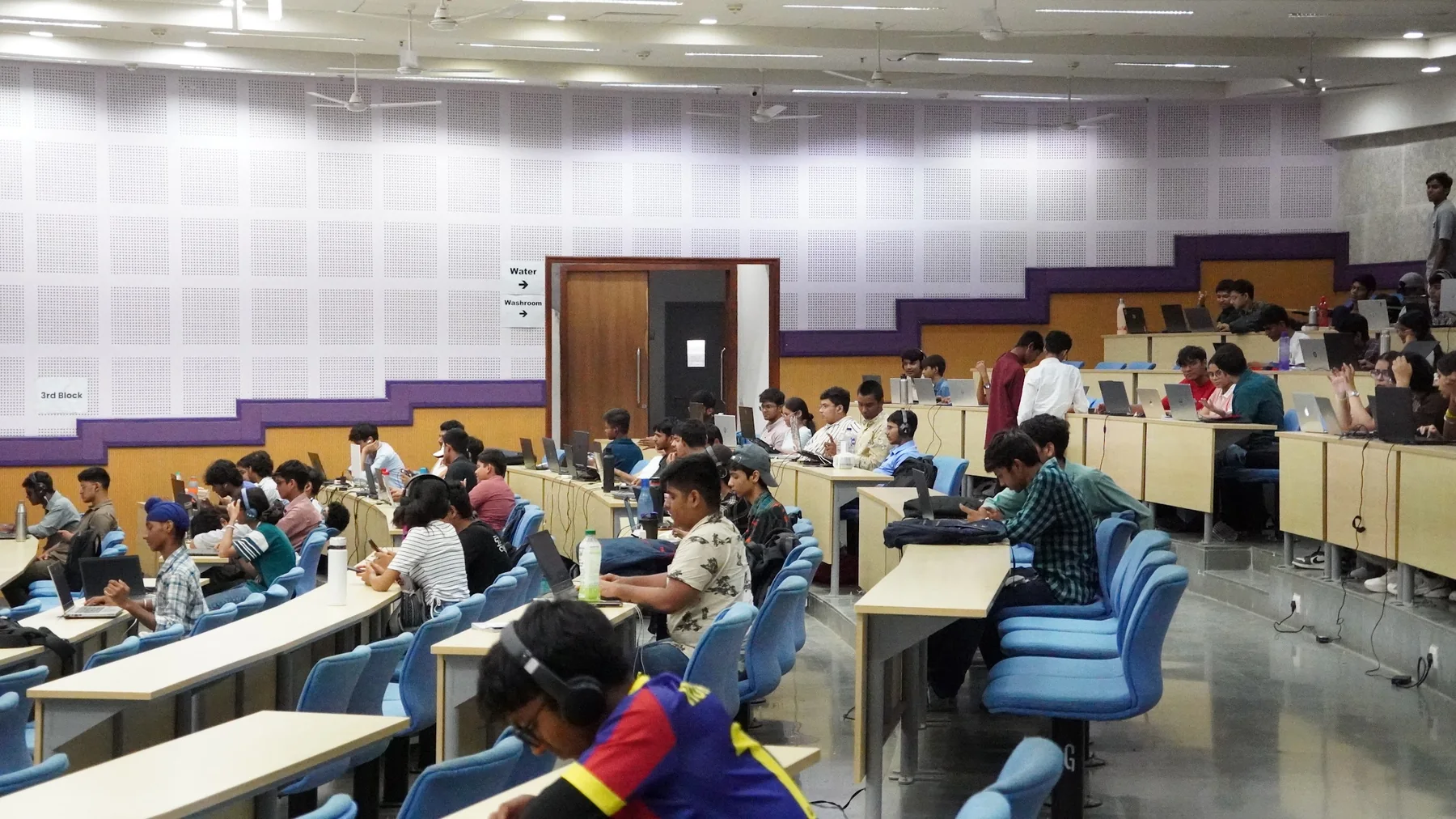 AAROH participants building with laptops across a full auditorium